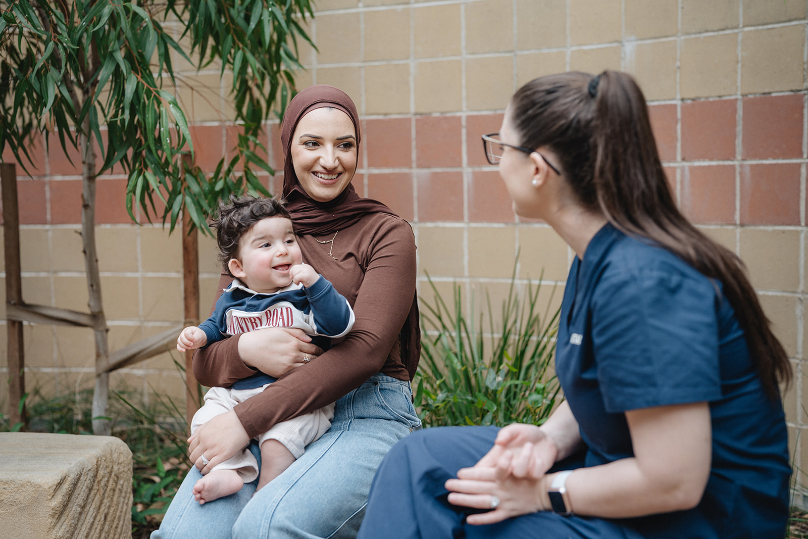 A Karitane Nurse with a mother and baby